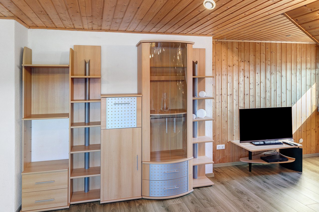 Wohnbereich mit Schrankwand und Fernseher, Fewo Tanja’s Blumenparadies in Hollfeld, Bayern