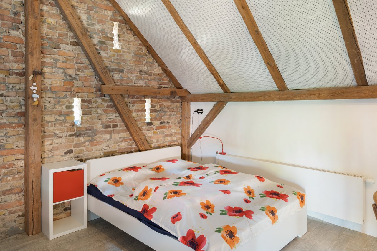 Schlafbereich mit Doppelbett unter der Dachschräge, Rotes Haus im Havelland in Werder (Havel), Brandenburg