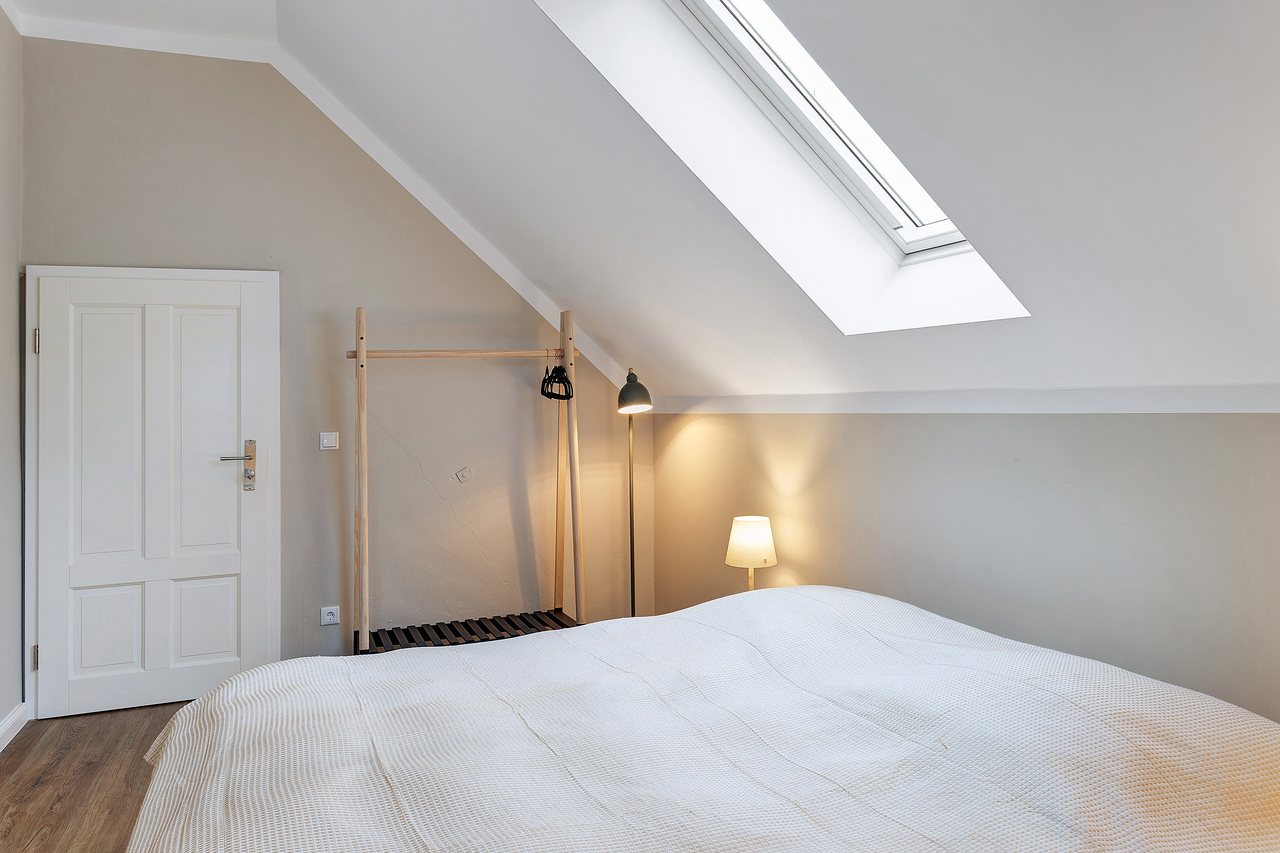 Doppelbett unter der Dachschräge mit Tür, Doppelzimmer in Marienfließ, Brandenburg